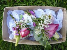 Buttonholes with pink roses, gypsophila and greenery